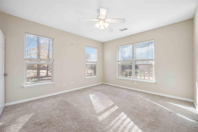 carpeted spare room featuring ceiling fan