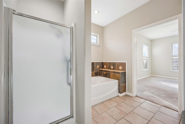 bathroom with independent shower and bath and tile patterned flooring