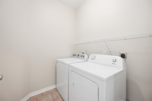 laundry room featuring light tile patterned floors and independent washer and dryer