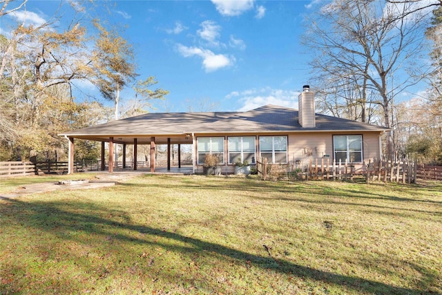 rear view of house with a lawn