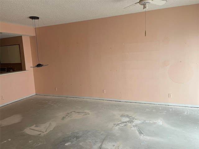 spare room featuring concrete flooring and a textured ceiling