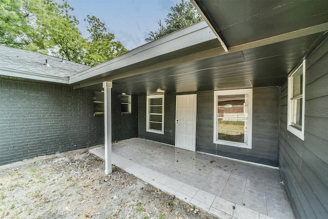 entrance to property featuring a patio