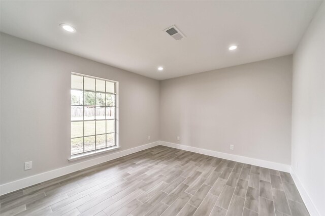 spare room featuring light hardwood / wood-style floors