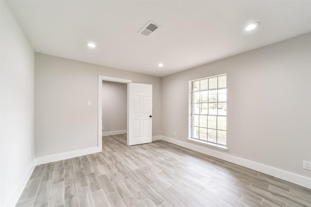 spare room featuring light wood-type flooring