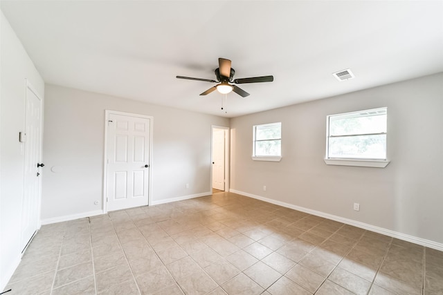 empty room featuring light tile patterned floors and ceiling fan