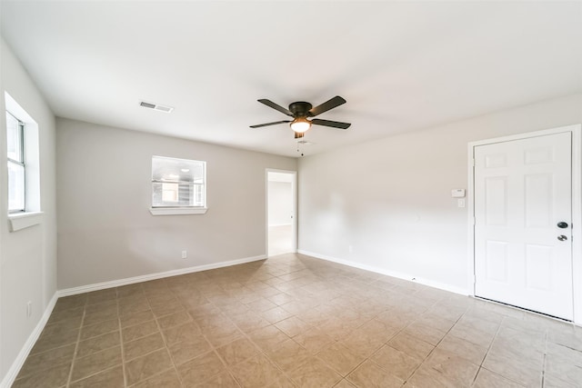 unfurnished room featuring ceiling fan and a healthy amount of sunlight