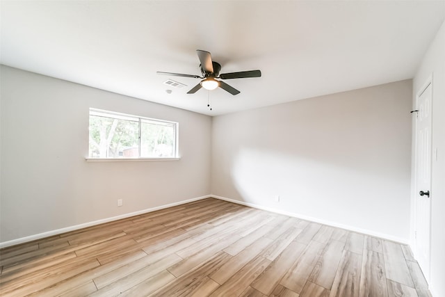 spare room with ceiling fan and light wood-type flooring