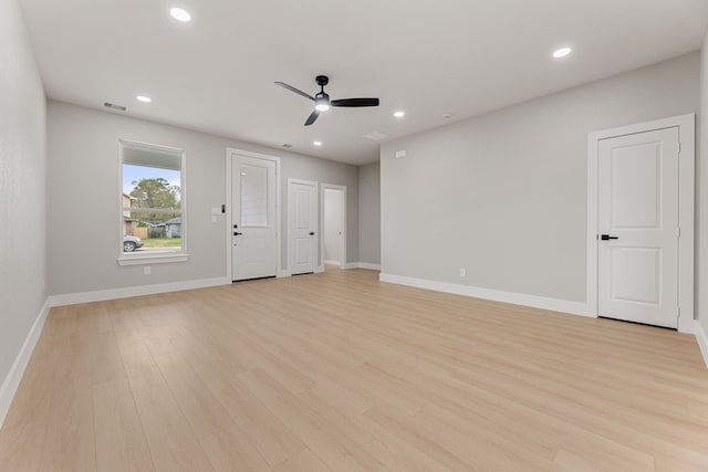 unfurnished living room featuring ceiling fan and light hardwood / wood-style floors