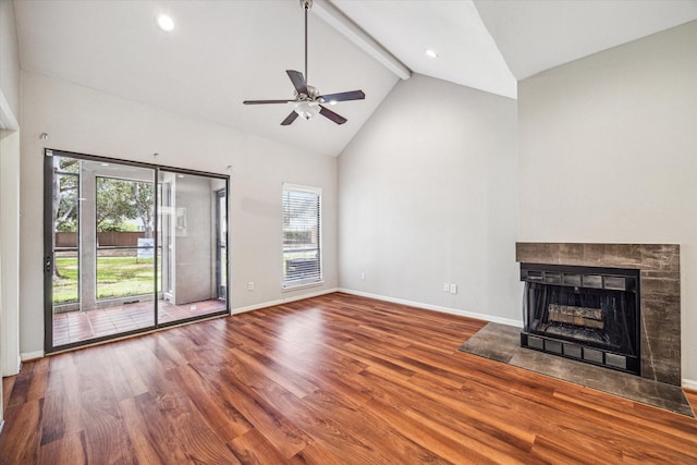 unfurnished living room with hardwood / wood-style flooring, ceiling fan, beam ceiling, high vaulted ceiling, and a multi sided fireplace