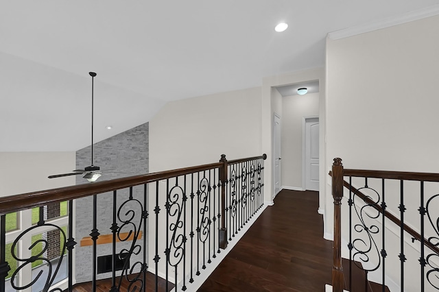 corridor with lofted ceiling and dark hardwood / wood-style floors