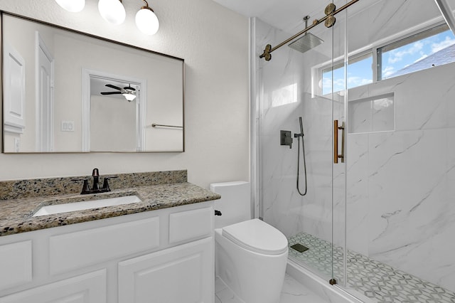 bathroom with vanity, an enclosed shower, ceiling fan, and toilet