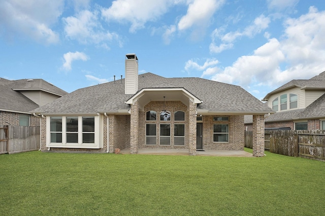 back of house with a lawn and a patio area