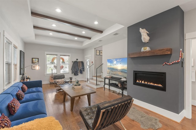 living room featuring a large fireplace, baseboards, wood finished floors, beam ceiling, and recessed lighting