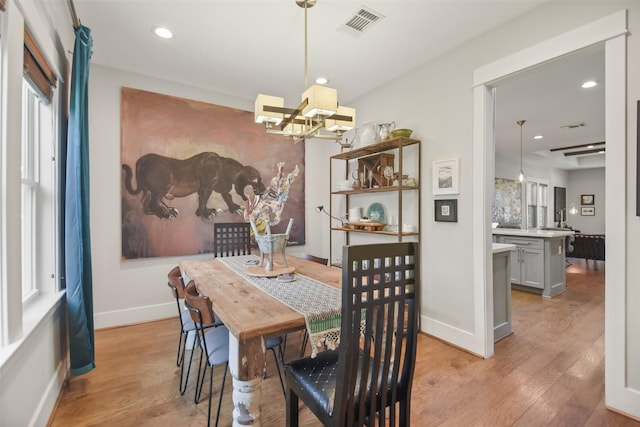 dining room featuring light wood-type flooring, visible vents, baseboards, and recessed lighting