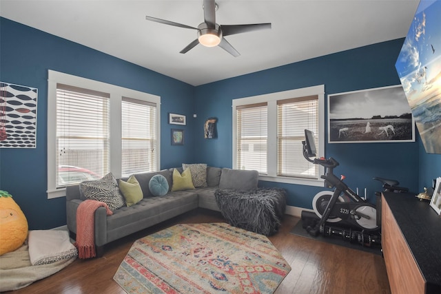 living room featuring dark wood-style floors, ceiling fan, and a healthy amount of sunlight