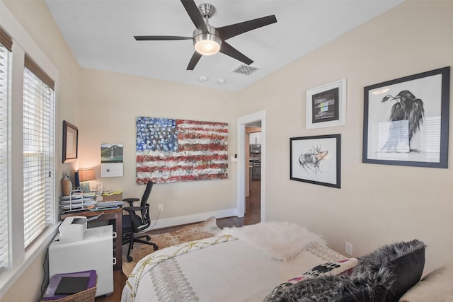 bedroom featuring a ceiling fan, visible vents, and baseboards