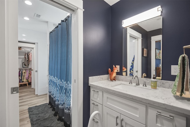 full bath with recessed lighting, visible vents, vanity, and wood finished floors