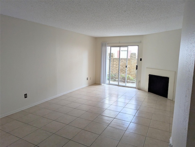 unfurnished living room featuring light tile patterned flooring and a textured ceiling