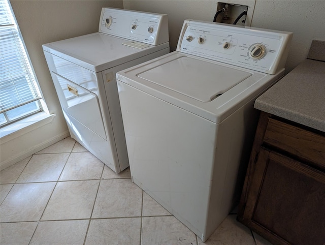 washroom featuring separate washer and dryer and light tile patterned floors