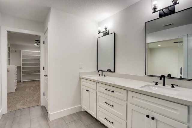 bathroom with vanity and a textured ceiling