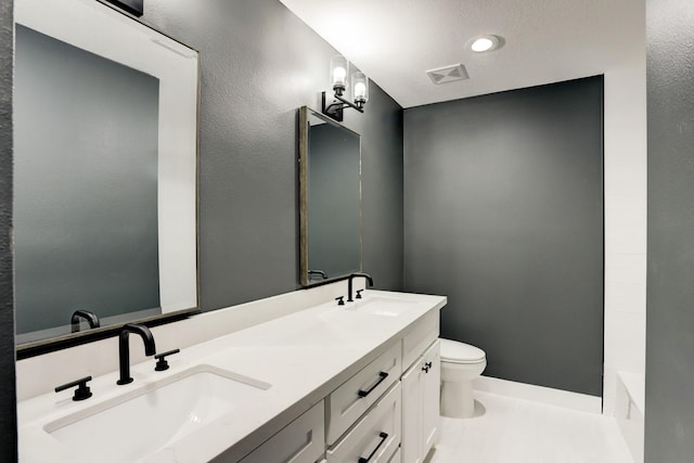 bathroom featuring vanity and toilet