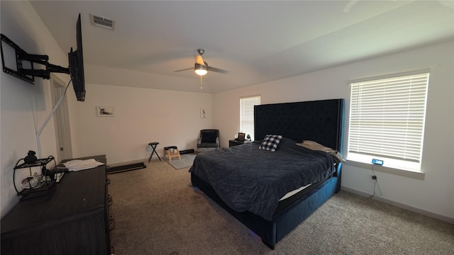 bedroom with ceiling fan and dark carpet