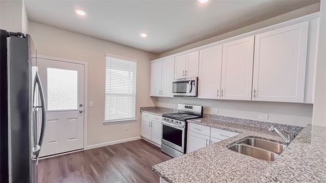 kitchen featuring white cabinetry, stainless steel appliances, and sink