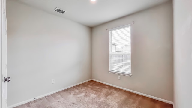 unfurnished room featuring light colored carpet