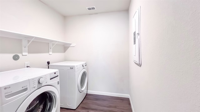 laundry area featuring dark hardwood / wood-style floors and washer and clothes dryer