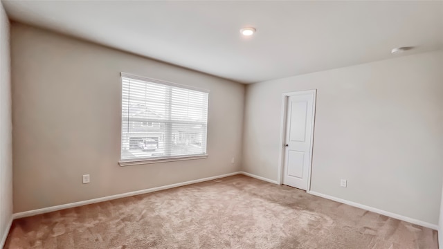 spare room with light carpet