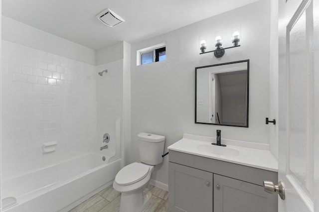 full bathroom with tiled shower / bath combo, vanity, and toilet