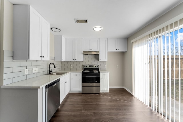 kitchen featuring sink, white cabinetry, dark hardwood / wood-style flooring, stainless steel appliances, and decorative backsplash