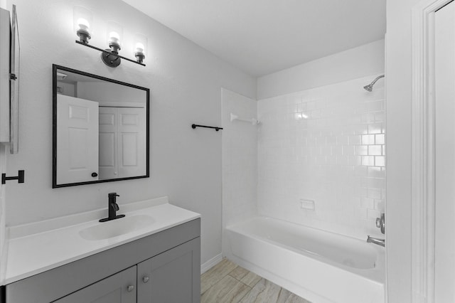 bathroom with vanity and tiled shower / bath combo