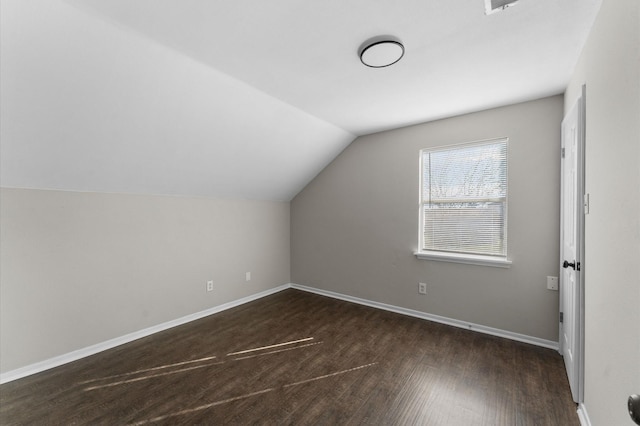 bonus room featuring vaulted ceiling and dark hardwood / wood-style floors