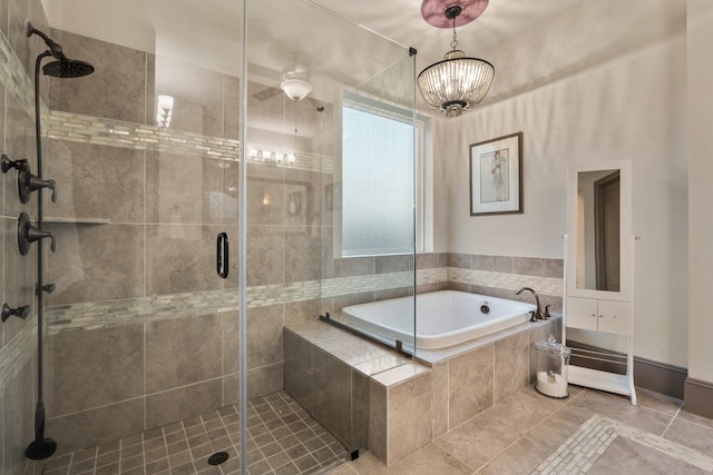 bathroom with independent shower and bath, a notable chandelier, and tile patterned floors