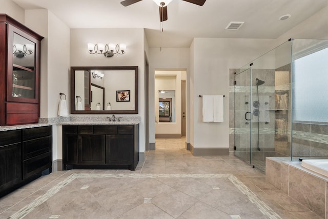 bathroom featuring plus walk in shower, vanity, and ceiling fan