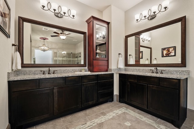 bathroom featuring walk in shower, ceiling fan, vanity, and tile patterned floors