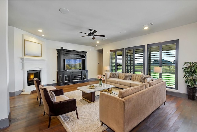 living room with ceiling fan and dark hardwood / wood-style flooring