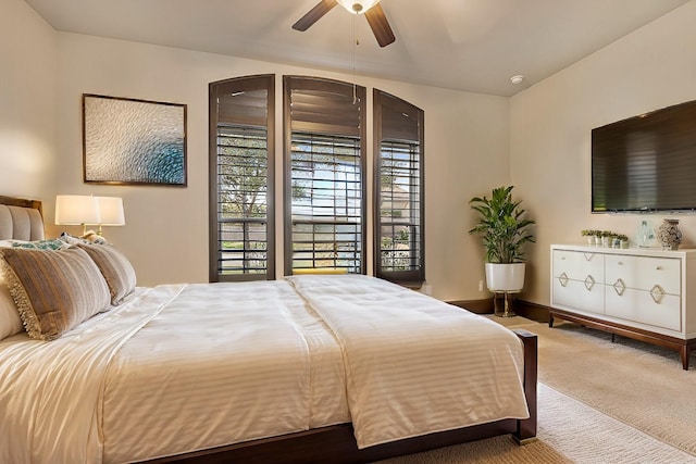 bedroom featuring ceiling fan and carpet