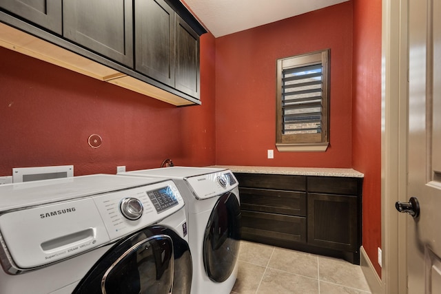 laundry area with cabinets, light tile patterned floors, and independent washer and dryer