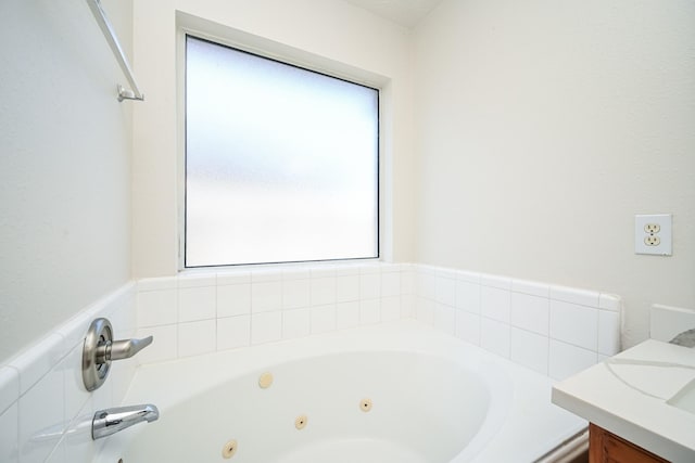 bathroom featuring vanity and a washtub