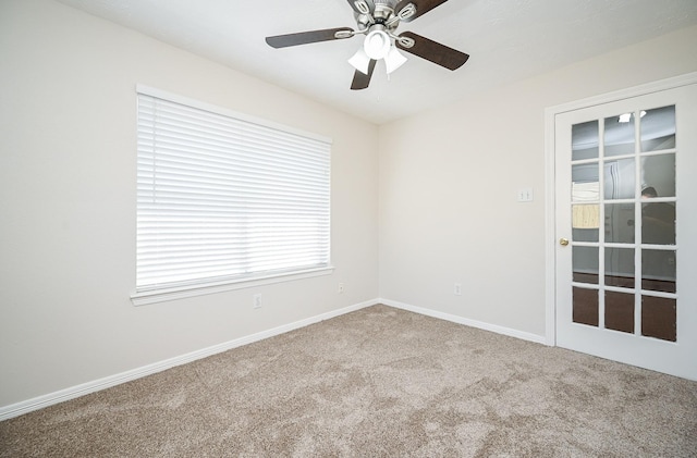 carpeted spare room with ceiling fan