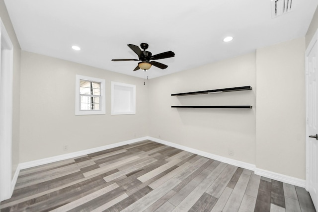 spare room with ceiling fan and light hardwood / wood-style floors