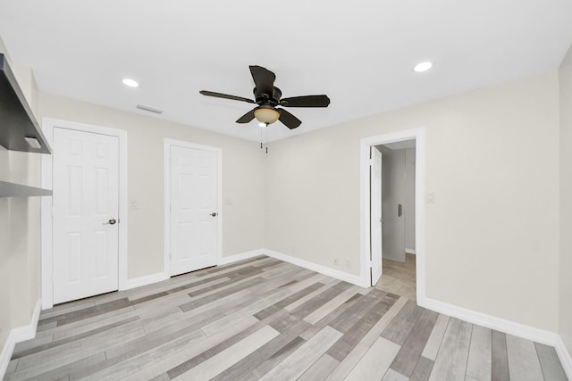 unfurnished bedroom with light hardwood / wood-style floors and ceiling fan