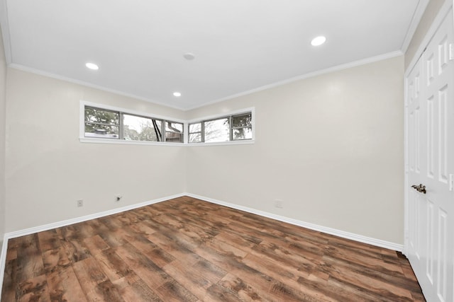 basement featuring crown molding and dark wood-type flooring