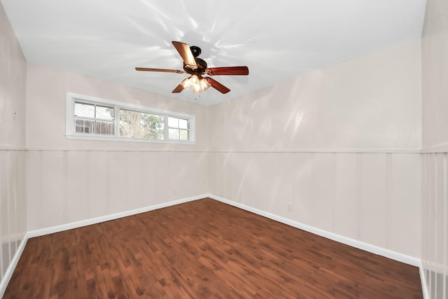 spare room with ceiling fan and dark hardwood / wood-style flooring