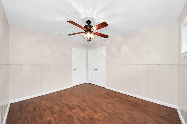 unfurnished room featuring ceiling fan and dark hardwood / wood-style flooring