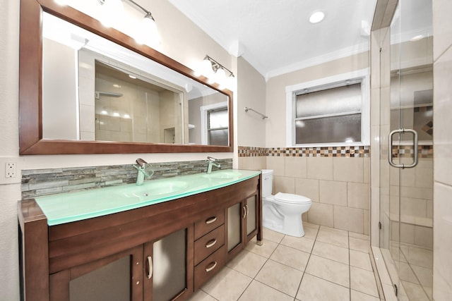 bathroom with a shower with door, tile walls, tile patterned flooring, vanity, and ornamental molding