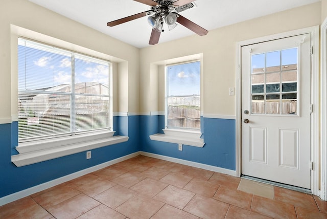 doorway to outside with light tile patterned floors and ceiling fan