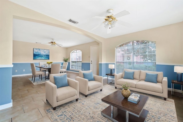 tiled living room featuring ceiling fan